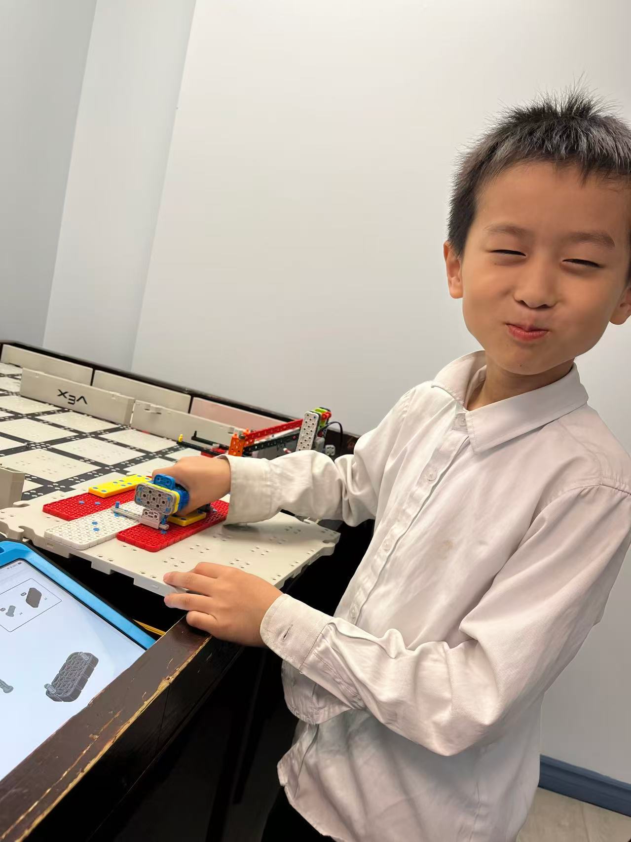 Younger students building robots in a bright classroom